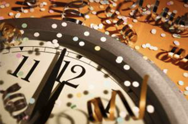 new year's scene with clock striking midnight